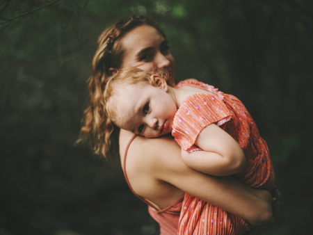 photo of a woman holding a child by Mary Amor