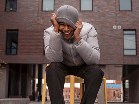 Photo of a man sitting on a chair outside of a building by Thomas Larson