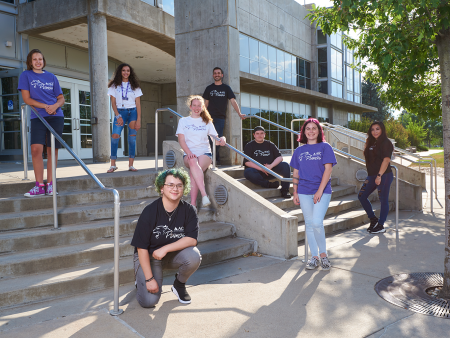 ACC students staggered on the stairs in front of the main entrance of the Littleton Campus main building.
