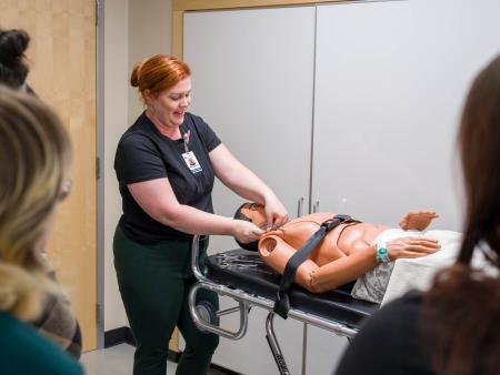 ACC Mortuary Science faculty using a dummy to demonstrate procedures at ACC's Littleton Campus.