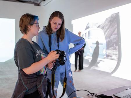 ACC photography student reviewing photos with industry professional during class session.