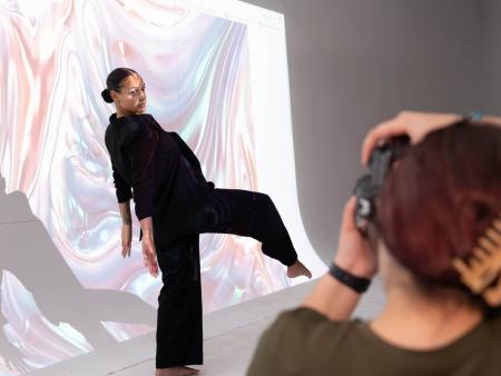 ACC commercial photography student taking photo of high fashion model in a studio.