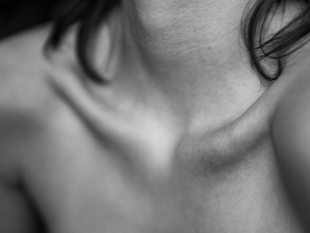 Black and white photo of a woman's collarbone and shoulders