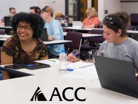 ACC students sitting at tables with laptops and ACC logo.
