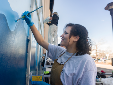 ACC art student painting a mural in Littleton, Colorado.