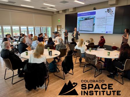 Participants at ACC's Space Educator Bootcamp sitting at tables and viewing presentation.