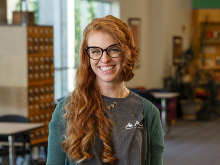 Lara Beckwith, ACC Access Services Librarian standing in the Library & Learning Commons at the Littleton Campus