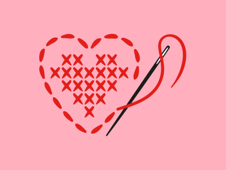 Needle and red thread cross-stiching a heart shape