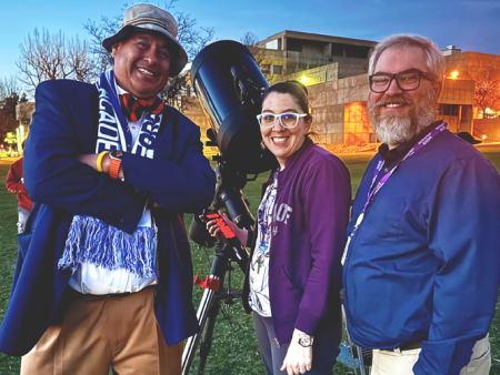 ACC astronomy faculty and instructors pose next to a telescope on the West Lawn of the Littleton Campus during a Star Party event.