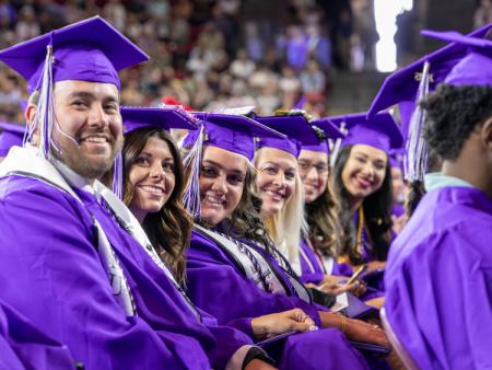 ACC graduates posing for photo at 2025 Commencement ceremony.