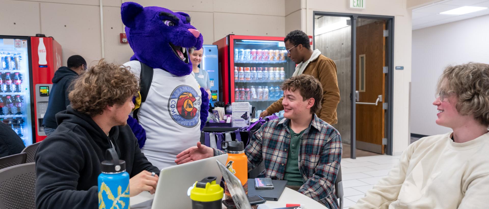 ACC puma mascot Summit interacts with students in the student lounge on the 3rd floor of the main building on the Littleton Campus.