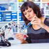 Woman working with robotic arm.