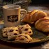 Photo of coffee cup and pastries on a plate - photo by Mercedes Gania