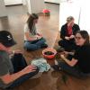 Students working with beads and twine at the Colorado Gallery of the Arts at ACC's Littleton Campus.