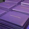 Stacks of Arapahoe Community College diplomas.