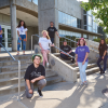ACC students staggered on the stairs in front of the main entrance of the Littleton Campus main building.