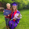 ACC Career Forward Graduate Weslyn Elder in regalia with diploma and child