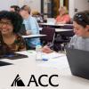 ACC students sitting at tables with laptops and ACC logo.