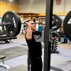 Derek Kates, ACC Fitness Center Manager, using free weights to do shoulder press in the ACC Fitness Center