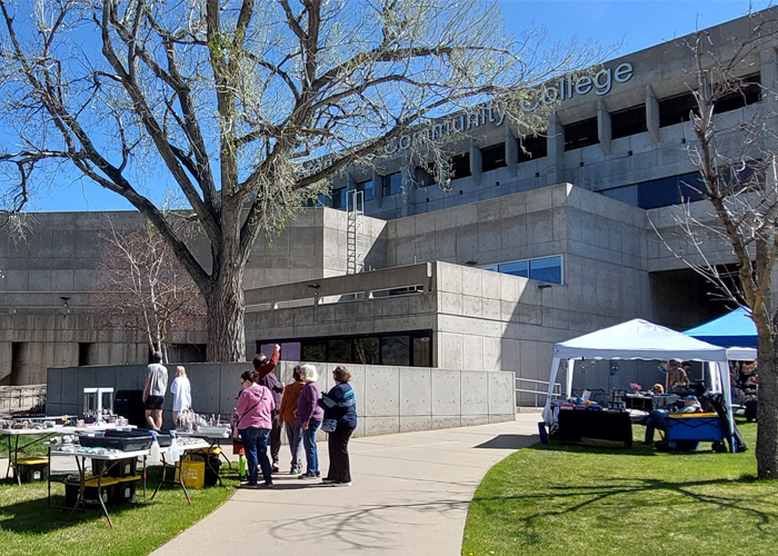 ACC Littleton Campus Main building west lawn, people exploring the outdoor craft fair.