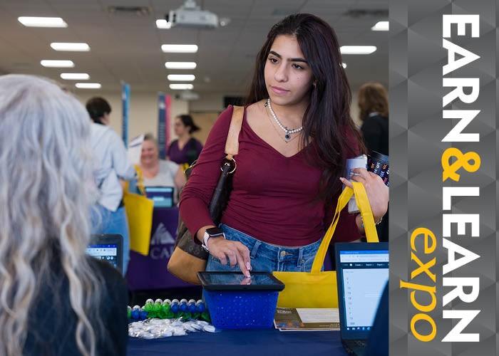 Earn & Learn Expo - ACC student at event talking to person at a table