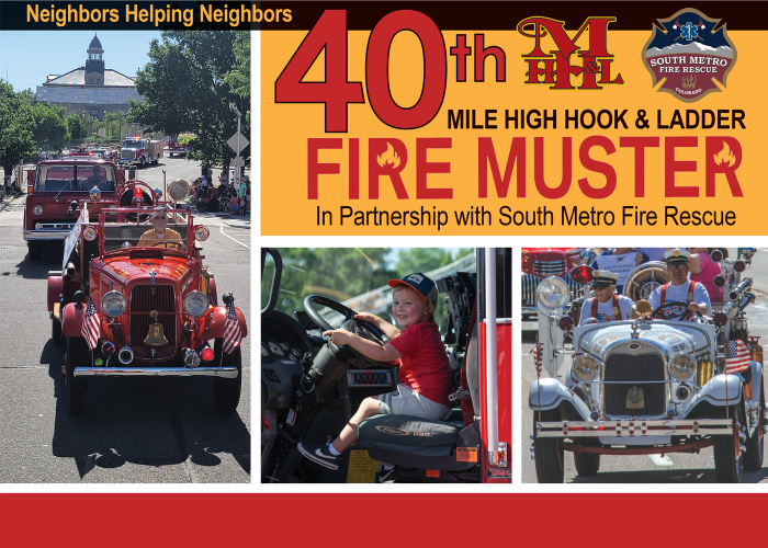 Firetrucks and response vehicles in a parade in downtown Littleton, Colorado. Child seated in driver's seat of fire truck. 