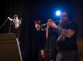 man playing trumpet on stage