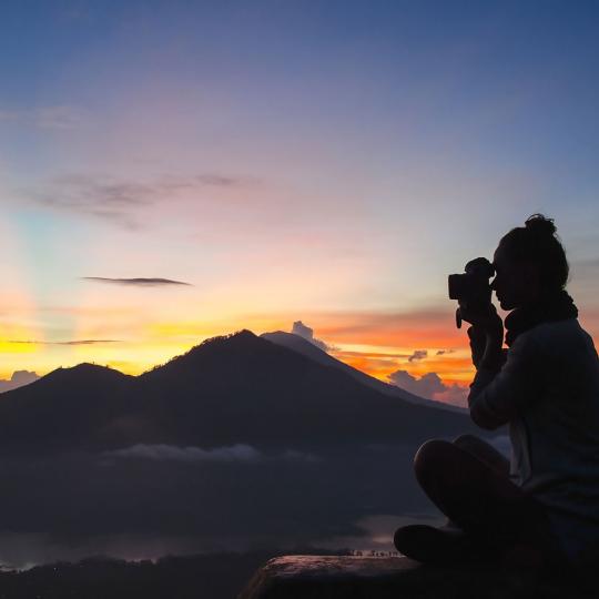 Woman photographing mountains
