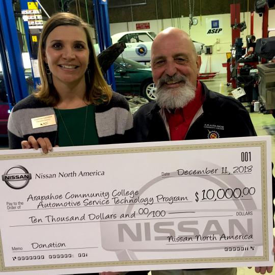 Courtney Loehfelm and Jerry Viola with check from Nissan North America