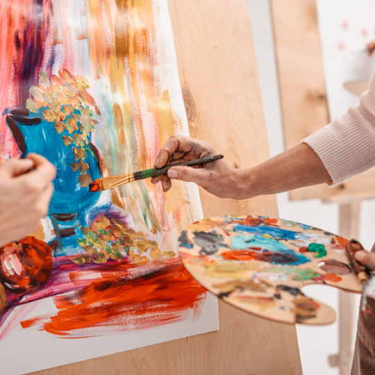 painter painting on canvas
