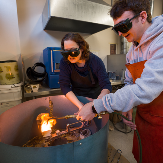 ACC art student and instructor creating metal jewelry at the Art & Design Center