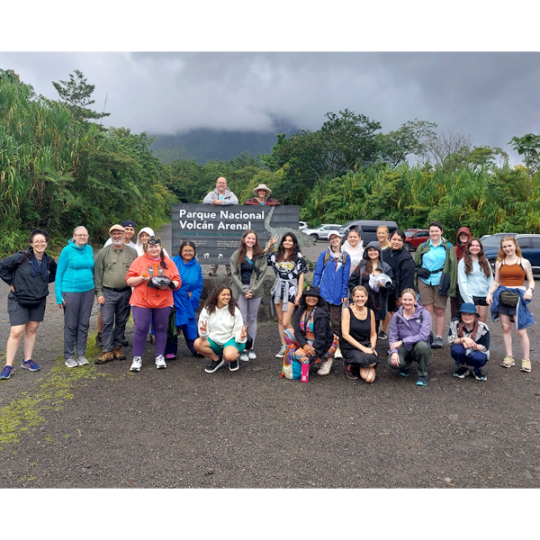 ACC study abroad group pose for a group photo by Parque Nacional Volcan Arenal. 