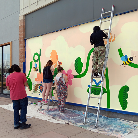 ACC art students painting a mural at Aspen Grove in Littleton, Colorado.