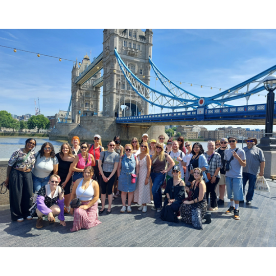 ACC students pose for a picture in front of a bridge during study abroad trip to the UK.