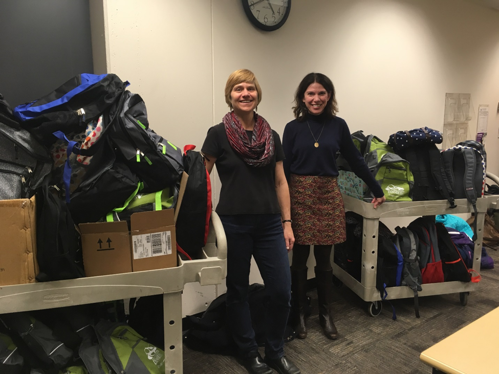 Diana Hornick and Josie Mills with filled backpacks